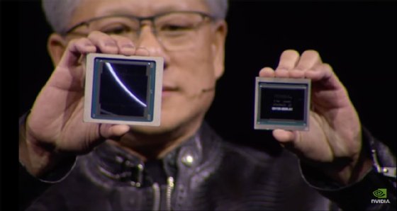 Image of Nvidia CEO Jensen Huang holding both Blackwell chips.