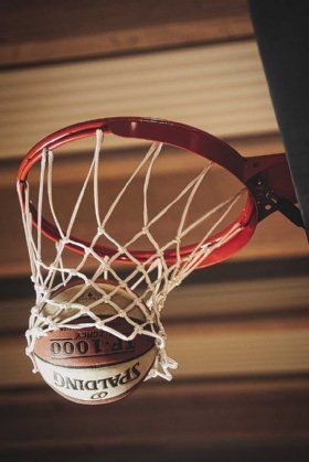 A basketball falls through the net.