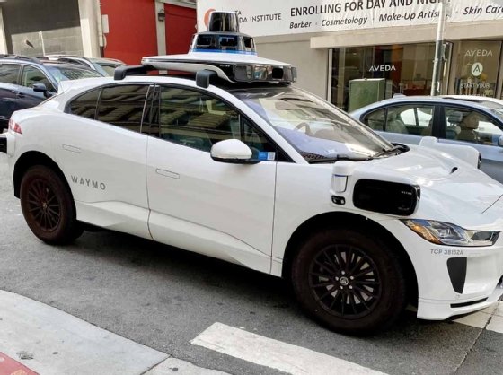 Photo of a Waymo self-driving taxi on the street.